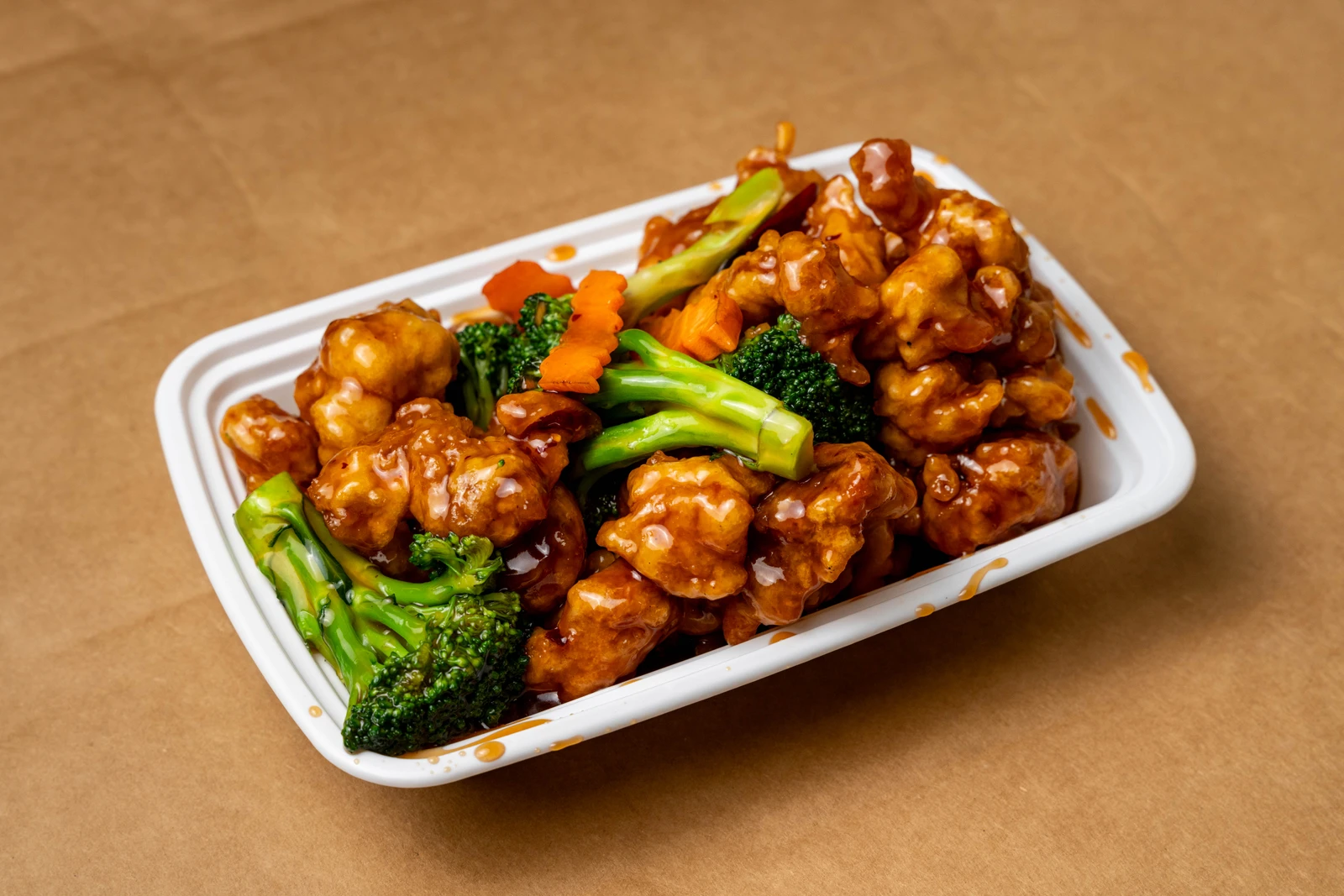 Golden House General Tso's Chicken with broccoli in a takeout container
